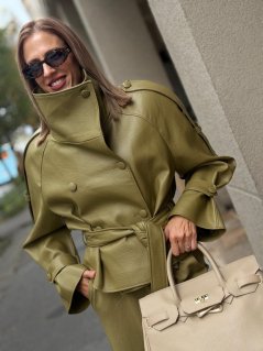 Olivovozelená bunda Verena z eko kože s vysokým golierom, opaskom v páse a gombíkovým zapínaním na modelke.
