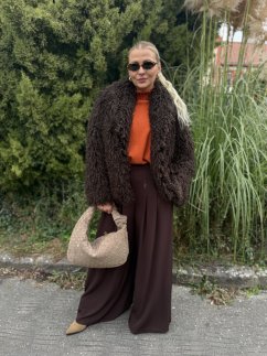 Dámsky hnedý kožúšok s teddy efektom, krátky oversize strih, elegantný jesenný outfit so širokými nohavicami a béžovou kabelkou. Dámsky hnedý kožúšok s teddy efektom, krátky oversize strih, elegantný jesenný outfit so širokými nohavicami a béžovou kabelkou.