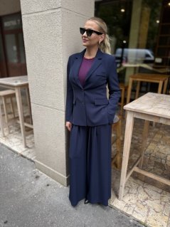 Dámsky tmavomodrý kostým so sakom a širokými nohavicami, elegantný business outfit s moderným strihom.